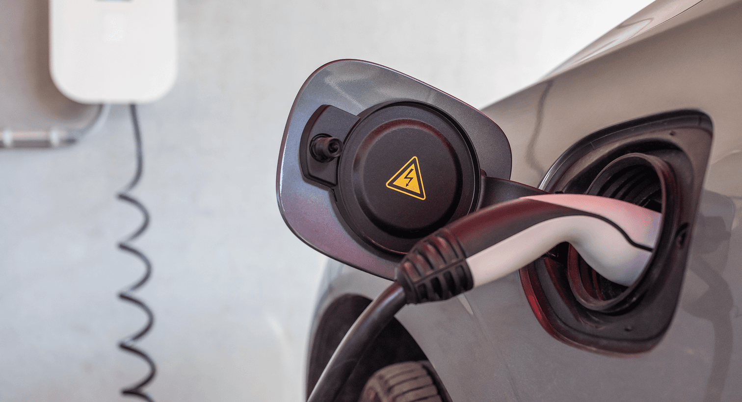 A charger plugged into an electric vehicle